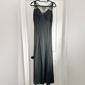 Floor length black dress with black beading design on the back.